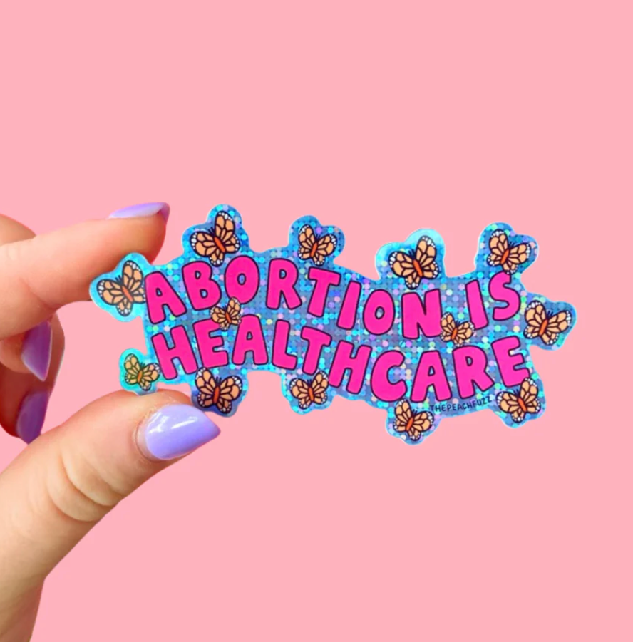 Sticker with pink bubble letters saying