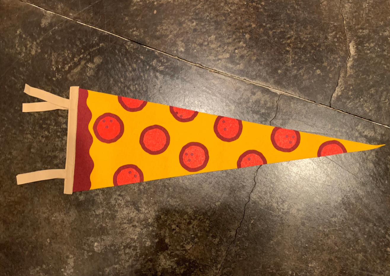 A pennant flag that looks like a slice of pepperoni pizza.