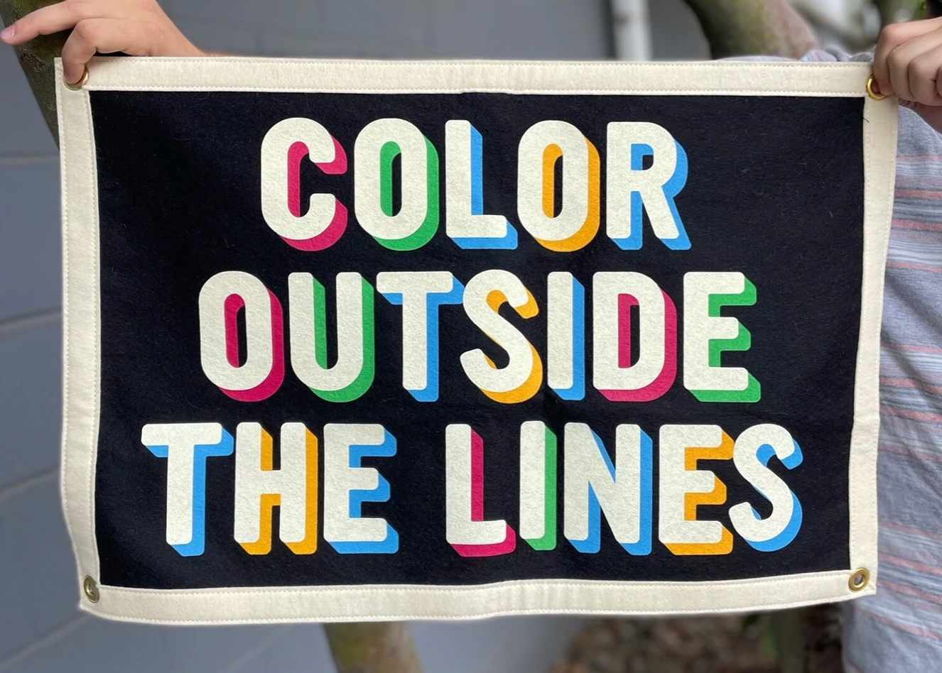 A banner with a cream border around a black box with the words