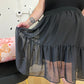 Black sheer skirt with long ruffled tier and elastic waist band.