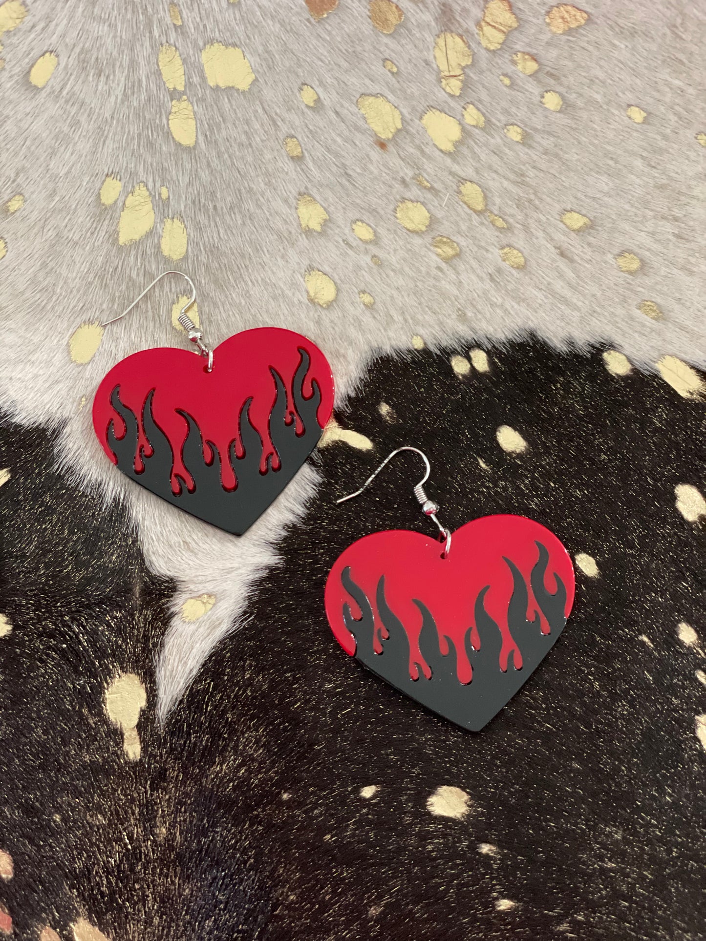 Big red heart dangly earrings with black flames.