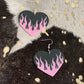 Big black dangly earrings with pink flames.
