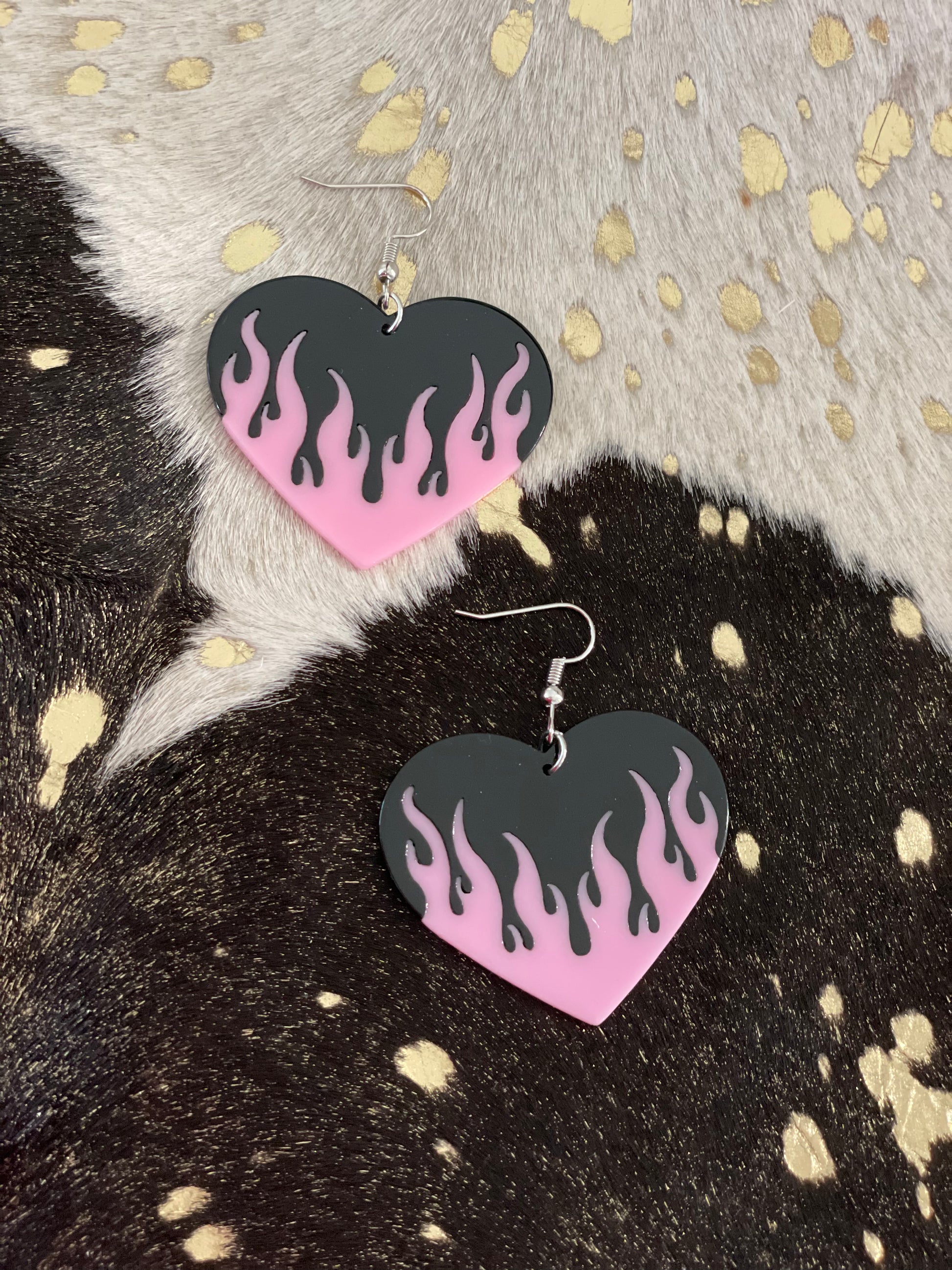 Big black dangly earrings with pink flames.