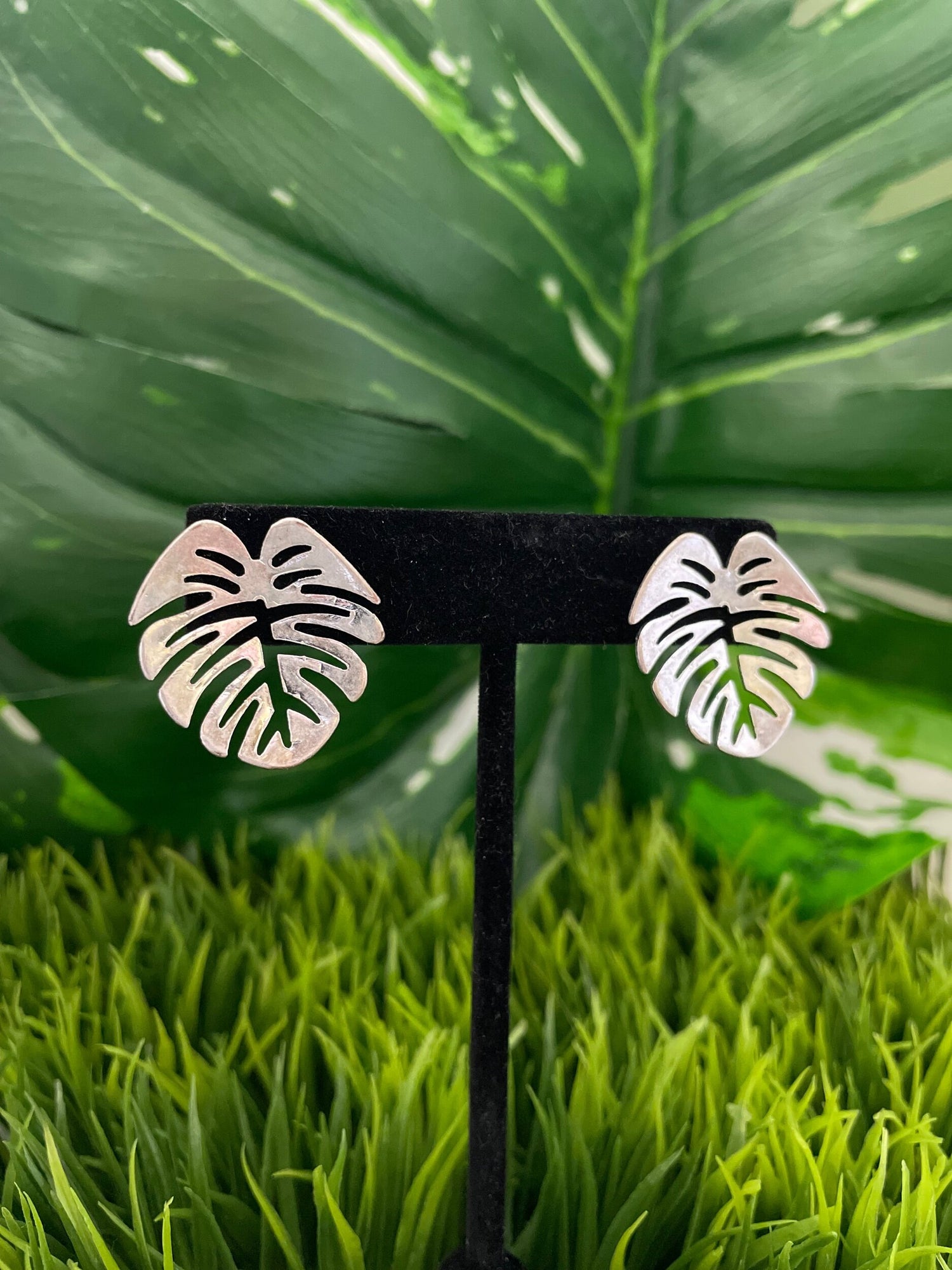 Gold post monstera earrings.