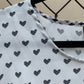 Close up of black hearts on white fabric