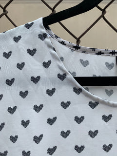 Close up of black hearts on white fabric