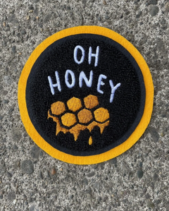 Black patch with yellow edge that says "Oh honey" in white letters with yellow honey comb underneath.