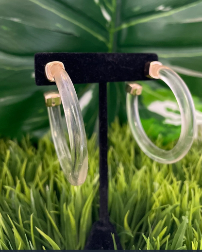 Clear post back hoop earrings with a gold cap on the end.