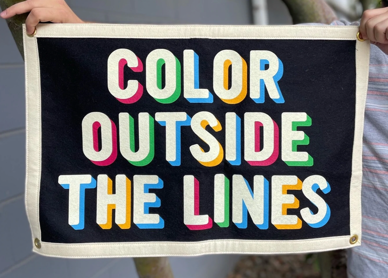 A banner with a cream border around a black box with the words 