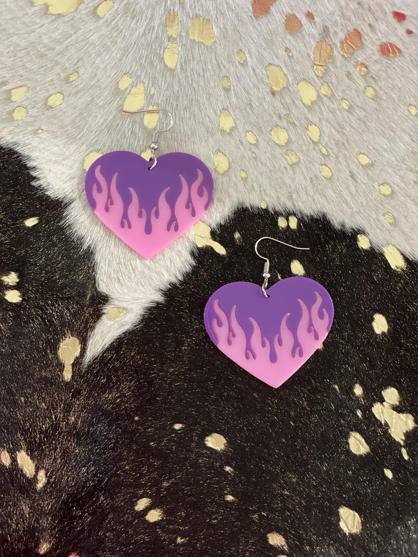 Big purple heart dangly earrings with pink flames.