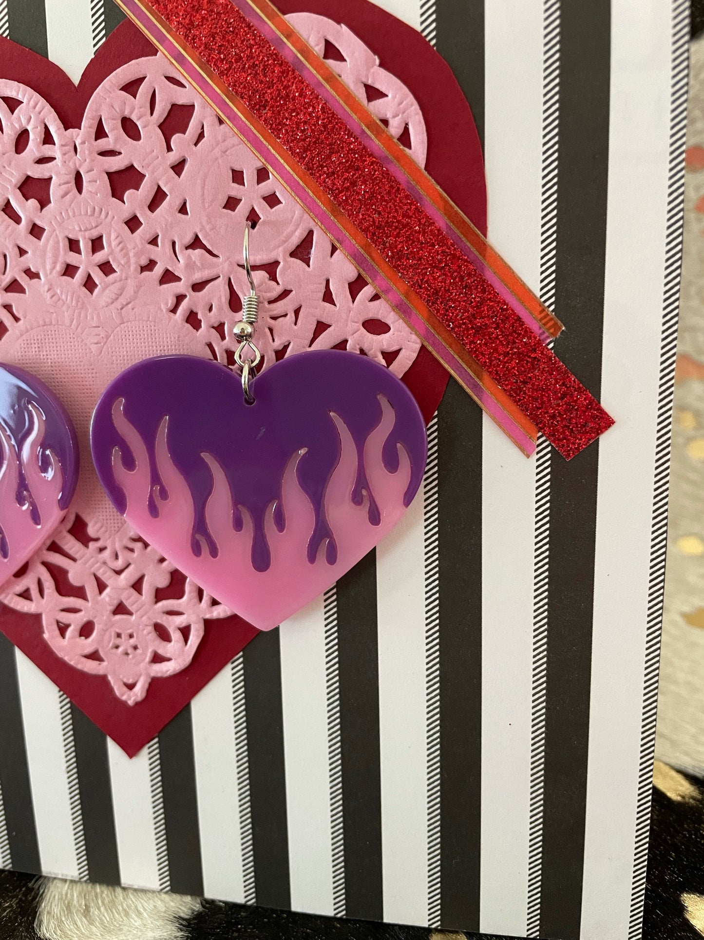 Big purple heart dangly earrings with pink flames.