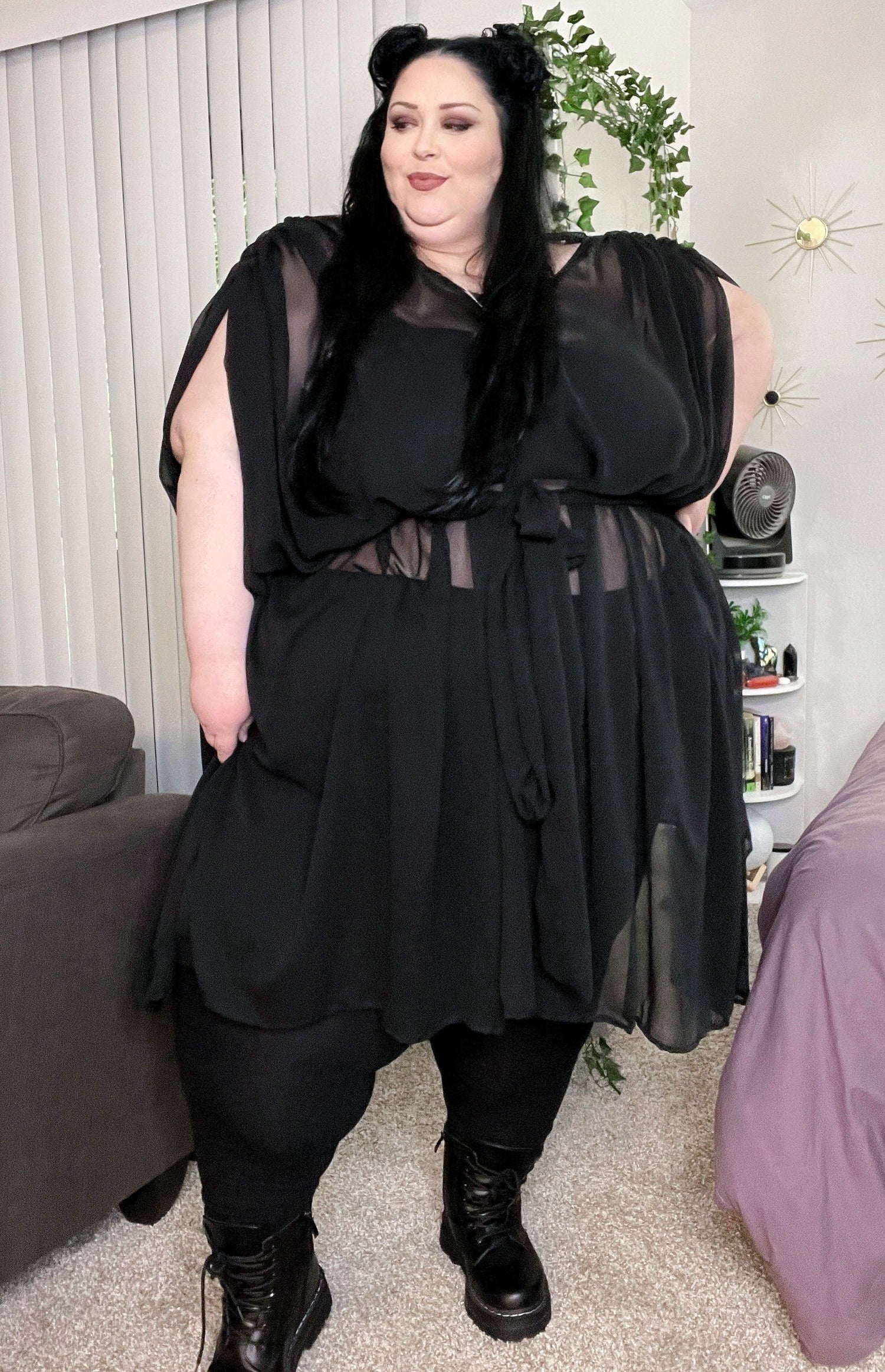 Sheer black flowy midi dress with tie around the middle. Shoulders are pleated and drape down as a sort of waterfall sleeve