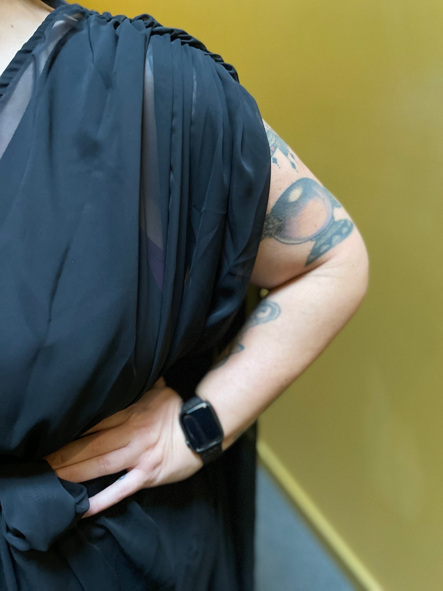 Close up of the gathered shoulder, fabric cascading over the cap of the shoulder