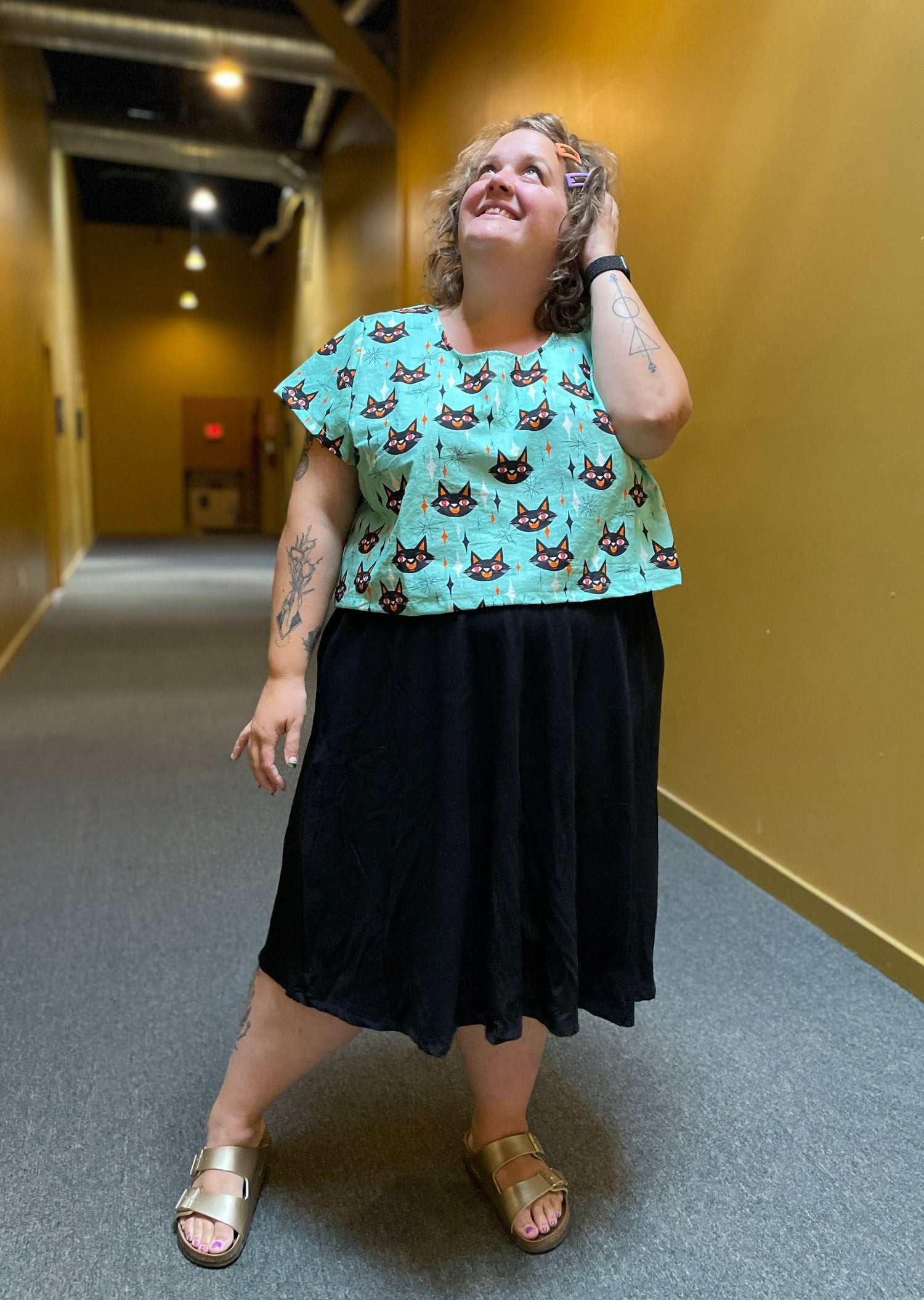 Blue short sleeved crop top with Black cats and vintage diamond and star pattern all over.