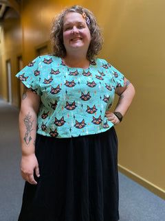 Blue short sleeved crop top with Black cats and vintage diamond and star pattern all over.